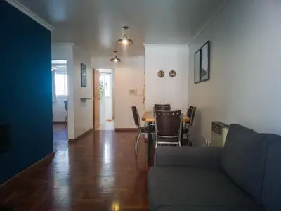 a living room with a couch and a table and chairs at Laprida y Trejo Apartamento in Cordoba