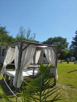 a tent with white curtains sitting in a yard at Las Brisas casas de campo un lugar para soñar in San Antonio de Arredondo