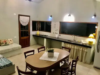 a kitchen and dining room with a table and a television at Las Brisas casas de campo un lugar para soñar in San Antonio de Arredondo
