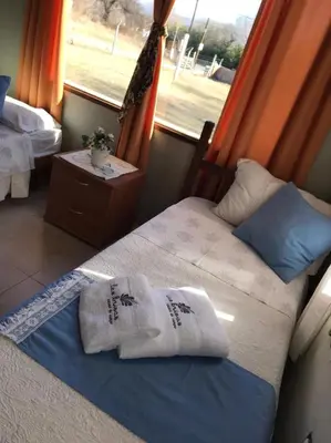 two beds in a room with a window at Las Brisas casas de campo un lugar para soñar in San Antonio de Arredondo