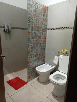 a bathroom with a toilet and a shower at FRAMA Cabañas del Lago in Potrero de Garay