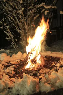 a fire burns in the snow at night at I Víla in Villa Carlos Paz
