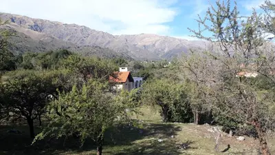 a house on a hill with mountains in the background at ASM CASA III in Merlo