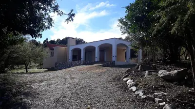 a house with a gravel driveway in front of it at ASM CASA III in Merlo