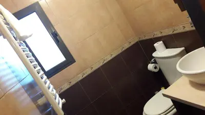 a bathroom with a toilet and a window at ASM CASA III in Merlo