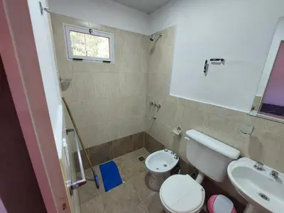 a bathroom with a toilet and a sink at Descanso Serrano in Santa Rosa de Calamuchita