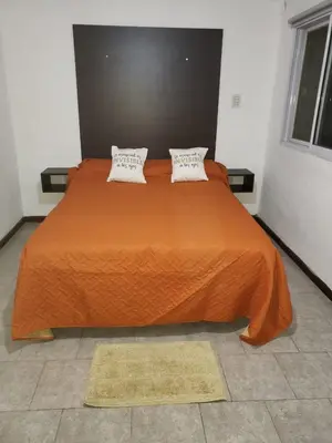 a large orange bed with two pillows on it at Descanso Serrano in Santa Rosa de Calamuchita