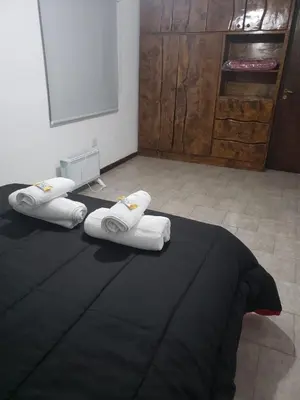 a room with a bed with towels on it at Descanso Serrano in Santa Rosa de Calamuchita