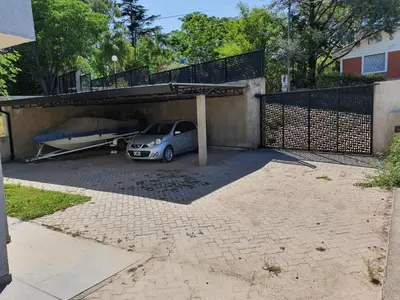 a car parked under a garage with a boat underneath it at Balcones del Lago in Villa Parque Siquiman