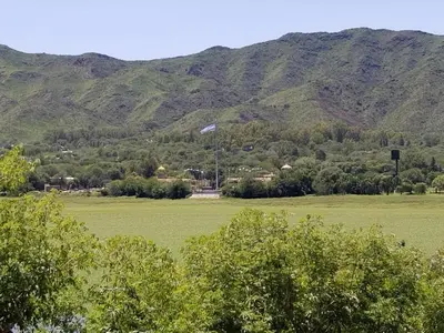a large green field with mountains in the background at Balcones del Lago in Villa Parque Siquiman