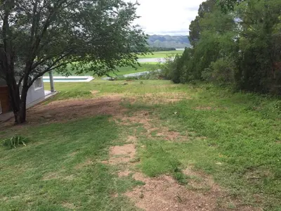 a dirt road in a field with trees at Balcones del Lago in Villa Parque Siquiman