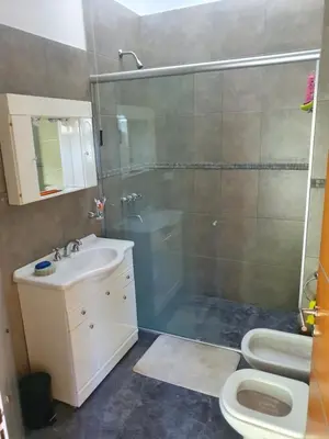 a bathroom with a shower and a sink and a toilet at Balcones del Lago in Villa Parque Siquiman