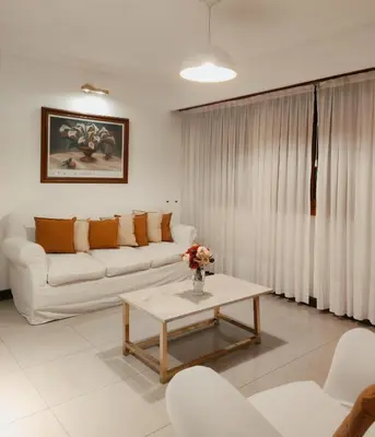 a living room with a couch and a table at HOTEL CASTELAR CORDOBA in Cordoba
