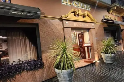 two potted plants sitting outside of a store at HOTEL CASTELAR CORDOBA in Cordoba