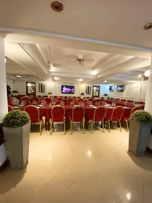 a large banquet hall with red tables and chairs at HOTEL CASTELAR CORDOBA in Cordoba