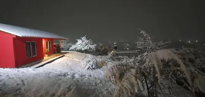 a red house covered in snow at night at Terrazas de Estancia in Villa Carlos Paz