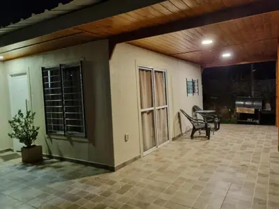 an outdoor patio with a bench and a table at Terrazas de Estancia in Villa Carlos Paz