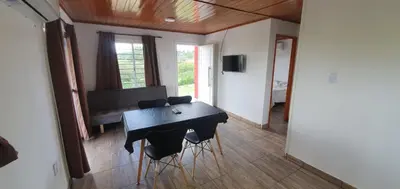 a dining room with a black table and chairs at Terrazas de Estancia in Villa Carlos Paz