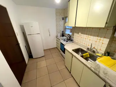 a small kitchen with a sink and a refrigerator at Amplio departamento ZONA CENTRO (2) in Cordoba