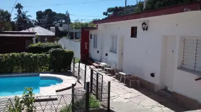 a house with a swimming pool next to a building at Amanitas Posada in Villa Carlos Paz