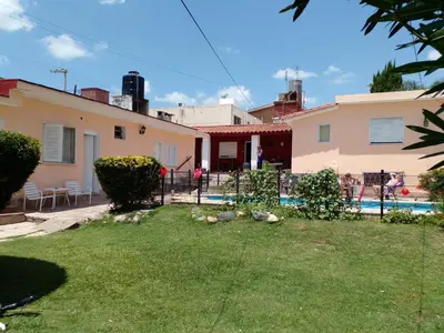 a backyard of a house with a swimming pool at Amanitas Posada in Villa Carlos Paz