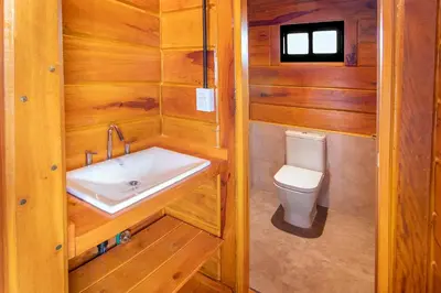 a bathroom with a sink and a toilet at Alma Serrana - Suites de montaña! in La Cumbrecita