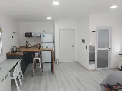 a kitchen with a table and a refrigerator at Love Sunset in Villa Carlos Paz