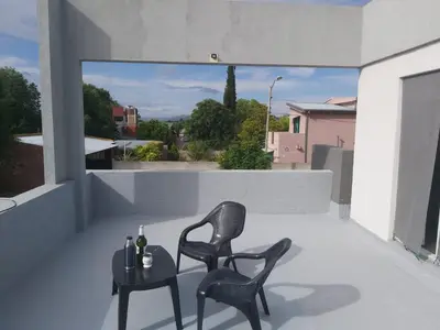 two chairs and a table on a balcony at Love Sunset in Villa Carlos Paz