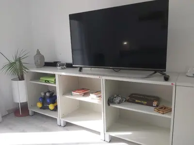 a flat screen tv on a white entertainment center at Love Sunset in Villa Carlos Paz
