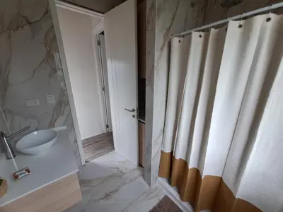 a bathroom with a sink and a shower curtain at Love Sunset in Villa Carlos Paz
