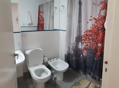 a bathroom with a toilet and a sink at Rosa de los vientos - Cofico in Cordoba