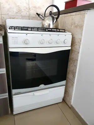 a white stove in a kitchen with a tea kettle on it at Rosa de los vientos - Cofico in Cordoba