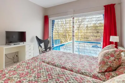 a bedroom with a bed and a large window at LA ARMONIA in Cordoba