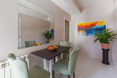 a dining room with a table and chairs and a painting at LA ARMONIA in Cordoba