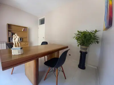 a room with a wooden desk and a potted plant at LA ARMONIA in Cordoba