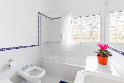 a white bathroom with a toilet and a sink at LA ARMONIA in Cordoba