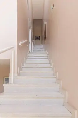 a stairway with white stairs in a building at LA ARMONIA in Cordoba
