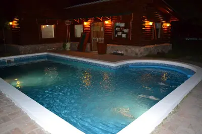 a swimming pool at night in front of a house at Las Esmeraldas in Nono