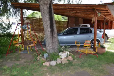 a swing and a car parked next to a tree at Las Esmeraldas in Nono