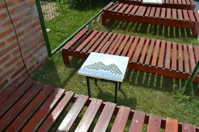 a sign on a table next to two benches at Las Esmeraldas in Nono