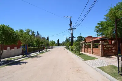 an empty road in a town with trees and a fence at Las Esmeraldas in Nono