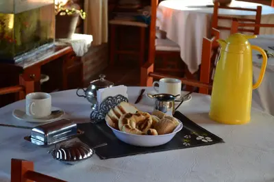 a table with a plate of bread and a pitcher of orange juice at Las Esmeraldas in Nono
