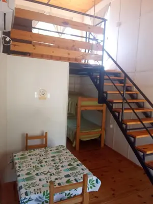 a room with a bunk bed and a staircase at Cabañas Guayacán in Bialet Massé