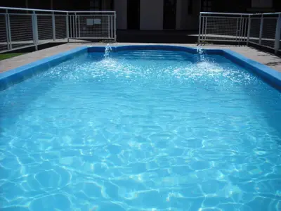 a large blue swimming pool with water in it at Hosteria Sueños Dorados in Merlo