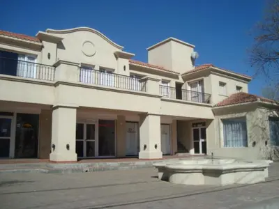 a large white house with a tub in front of it at La Candida Hotel in Merlo