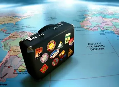 a suitcase sitting on top of a world map at Dpto con pileta y cochera Güemes - Nueva Córdoba -Seguridad 24 hs Terraza y asadores!! Balcón Panorámico! in Cordoba