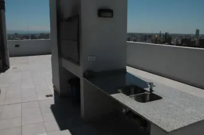 a kitchen counter with a sink on a balcony at Dpto con pileta y cochera Güemes - Nueva Córdoba -Seguridad 24 hs Terraza y asadores!! Balcón Panorámico! in Cordoba