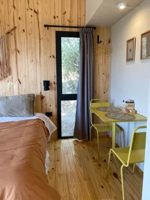 a bedroom with a bed and a desk and a table at Finca Granero in Potrero de Garay