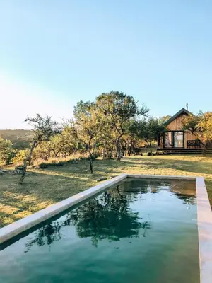 a pool of water in front of a house at Finca Granero in Potrero de Garay