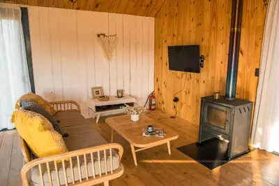 a living room with a couch and a wood stove at Finca Granero in Potrero de Garay